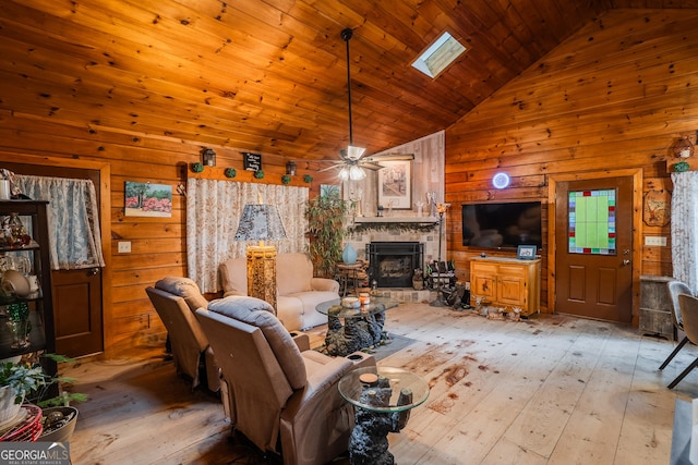 12 Scott Dr, Ellijay, GA 30540 - living room with wood walls, high vaulted ceiling, light wood-style floors, a fireplace, and ceiling fan