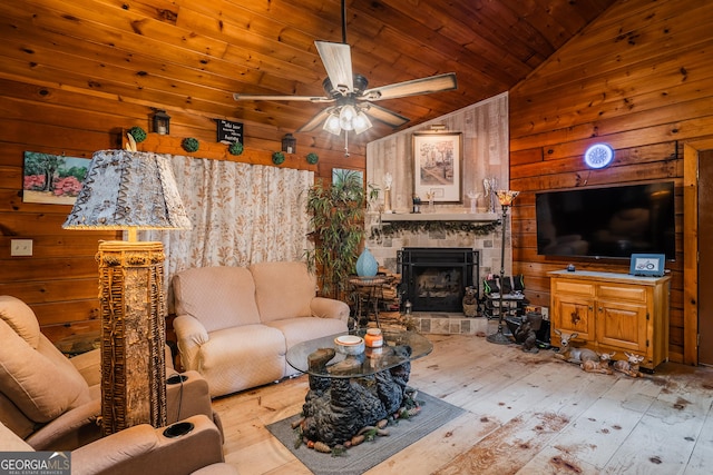12 Scott Dr, Ellijay, GA 30540 - living area with wood walls, lofted ceiling, hardwood / wood-style flooring, wooden ceiling, and an outdoor stone fireplace
