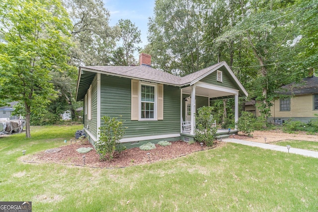 116 6th St, Monroe, GA 30655 - bungalow-style house featuring a porch, a front yard, crawl space, a chimney, and roof with shingles
