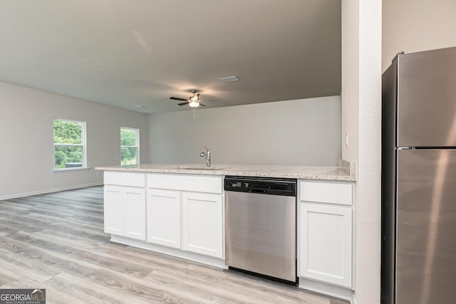 102 Avondale Blvd, Conyers, GA 30013 - kitchen featuring stainless steel appliances, a peninsula, a ceiling fan, white cabinets, and light wood-style flooring