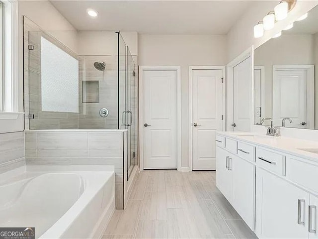 8415 Halford Way, Ball Ground, GA 30107 - full bathroom featuring a garden tub, double vanity, a shower stall, and recessed lighting