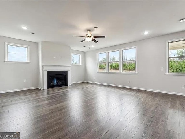 8415 Halford Way, Ball Ground, GA 30107 - unfurnished living room with a ceiling fan, healthy amount of natural light, a fireplace, dark wood-type flooring, and recessed lighting