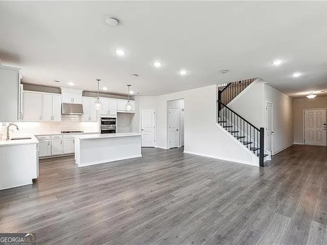 8415 Halford Way, Ball Ground, GA 30107 - kitchen with under cabinet range hood, double oven, recessed lighting, a center island, and open floor plan