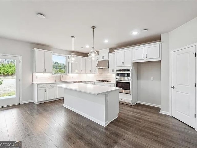 8415 Halford Way, Ball Ground, GA 30107 - kitchen featuring under cabinet range hood, appliances with stainless steel finishes, white cabinetry, backsplash, and recessed lighting