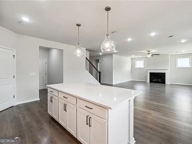 8415 Halford Way, Ball Ground, GA 30107 - kitchen featuring a ceiling fan, dark wood finished floors, white cabinets, light countertops, and pendant lighting