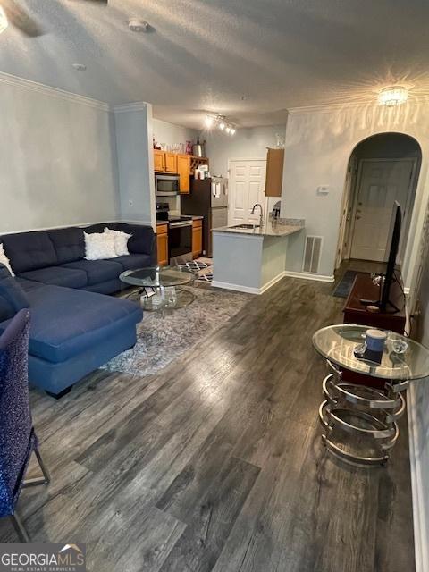 4333 Dunwoody Park Unit 2214, Atlanta, GA 30338 - living room featuring arched walkways, dark wood-type flooring, and ornamental molding