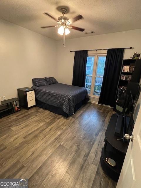 4333 Dunwoody Park Unit 2214, Atlanta, GA 30338 - bedroom featuring a textured ceiling, wood finished floors, and a ceiling fan