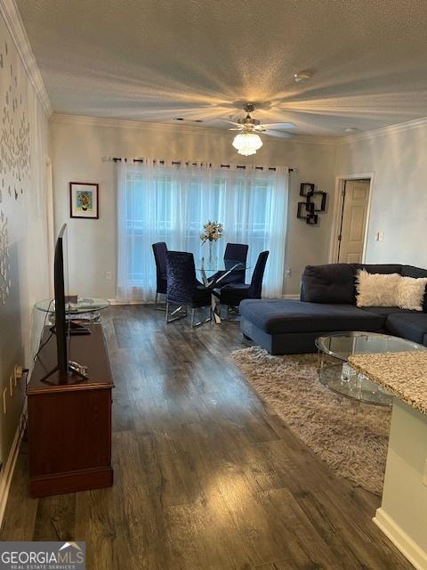 4333 Dunwoody Park Unit 2214, Atlanta, GA 30338 - living room featuring dark wood-style floors, a ceiling fan, a textured ceiling, healthy amount of natural light, and crown molding