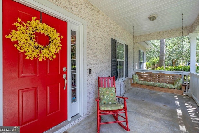 21 Hardwood Forest Cir, Brunswick, GA 31525 - doorway to property featuring covered porch and stucco siding
