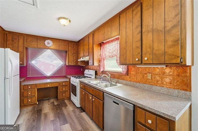 1159 Midland Dr NW, Acworth, GA 30102 - kitchen with white appliances, brown cabinetry, wood finished floors, decorative backsplash, and a textured ceiling