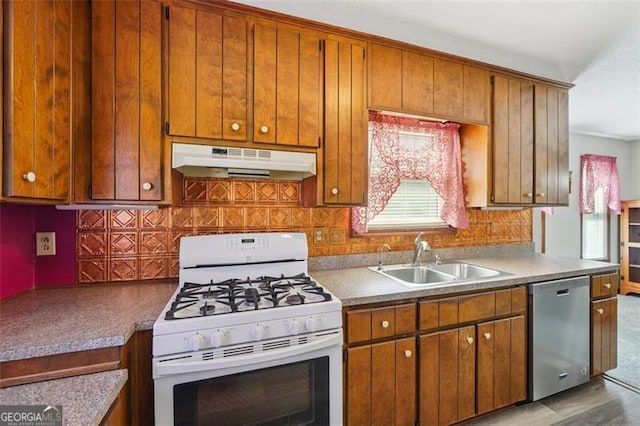 1159 Midland Dr NW, Acworth, GA 30102 - kitchen with white gas stove, under cabinet range hood, stainless steel dishwasher, and brown cabinetry