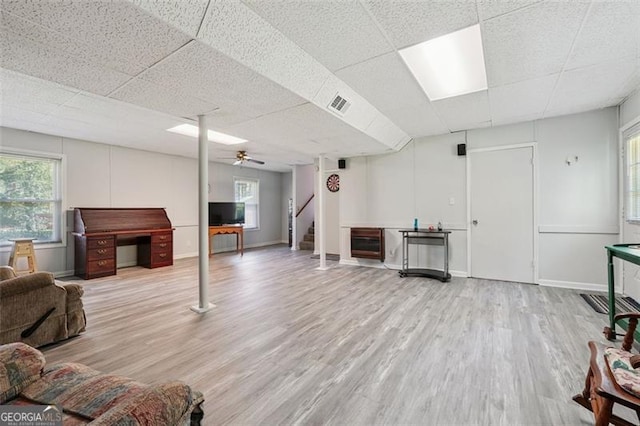 1159 Midland Dr NW, Acworth, GA 30102 - living room featuring a paneled ceiling, wood finished floors, healthy amount of natural light, ceiling fan, and stairs