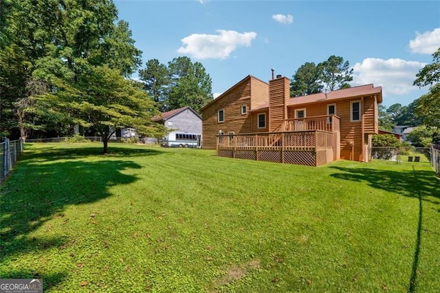 1159 Midland Dr NW, Acworth, GA 30102 - back of house featuring a fenced backyard, a wooden deck, and a chimney