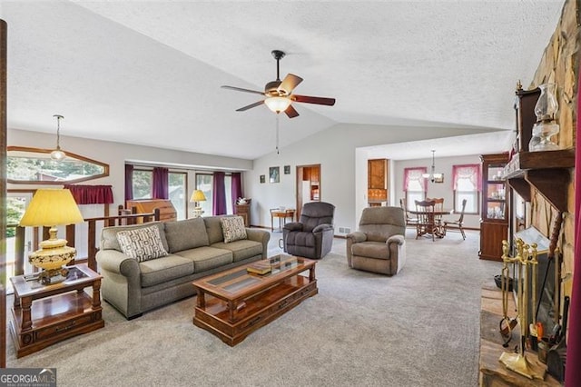 1159 Midland Dr NW, Acworth, GA 30102 - carpeted living room featuring a textured ceiling, vaulted ceiling, plenty of natural light, and a ceiling fan
