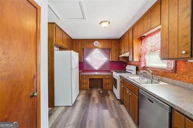 1159 Midland Dr NW, Acworth, GA 30102 - kitchen featuring white appliances, brown cabinets, dark wood-style flooring, and under cabinet range hood
