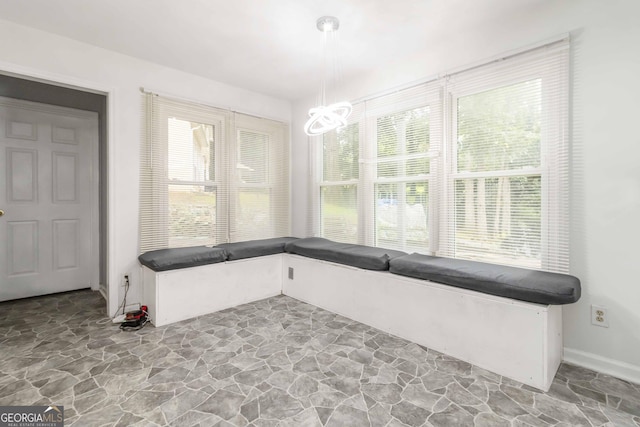 539 Riverbirch Trce, Stone Mountain, GA 30087 - unfurnished dining area with stone floors and a chandelier