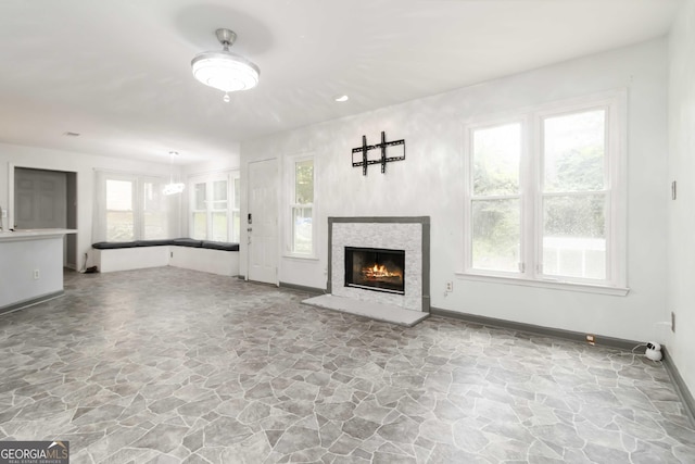 539 Riverbirch Trce, Stone Mountain, GA 30087 - unfurnished living room featuring stone flooring, a glass covered fireplace, and recessed lighting
