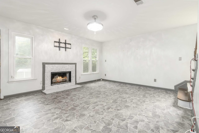 539 Riverbirch Trce, Stone Mountain, GA 30087 - unfurnished living room featuring stone floors and a glass covered fireplace
