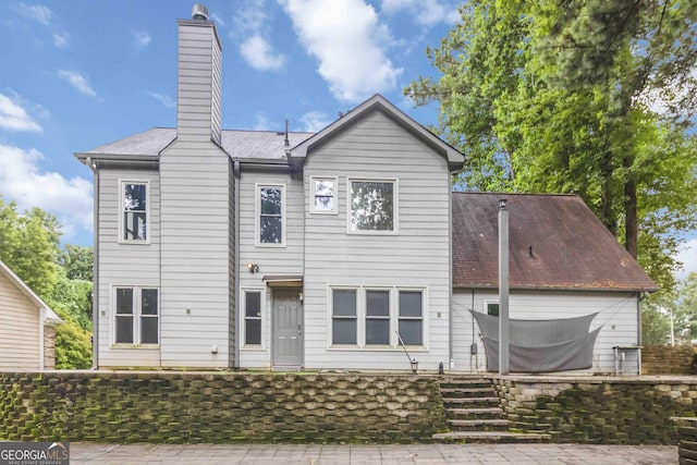 539 Riverbirch Trce, Stone Mountain, GA 30087 - back of house featuring a chimney