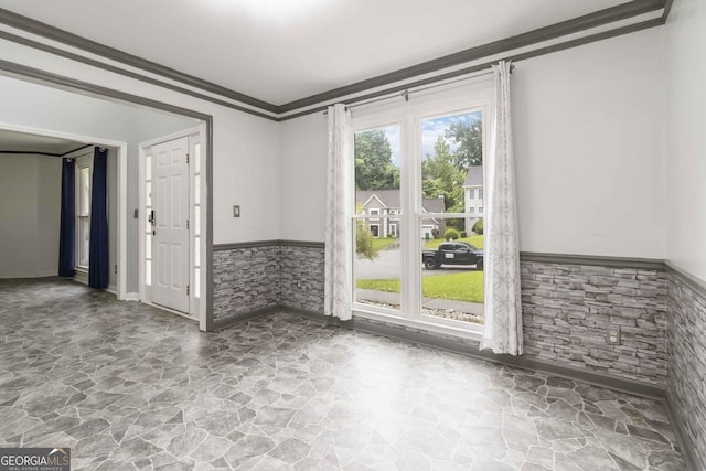 539 Riverbirch Trce, Stone Mountain, GA 30087 - spare room with stone flooring, a wainscoted wall, and crown molding