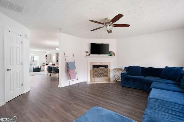 245 Weatherstone Pointe Dr, Woodstock, GA 30188 - living area featuring a textured ceiling, a ceiling fan, wood finished floors, and a fireplace with flush hearth