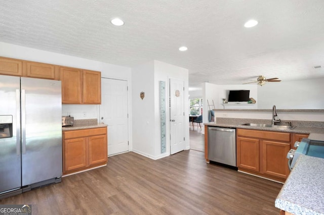 245 Weatherstone Pointe Dr, Woodstock, GA 30188 - kitchen with stainless steel appliances, dark wood-type flooring, ceiling fan, brown cabinetry, and recessed lighting
