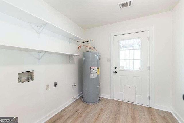 321 Riverbend Ct, Macon, GA 31211 - laundry area featuring electric water heater, electric dryer hookup, hookup for a washing machine, and light wood-style flooring