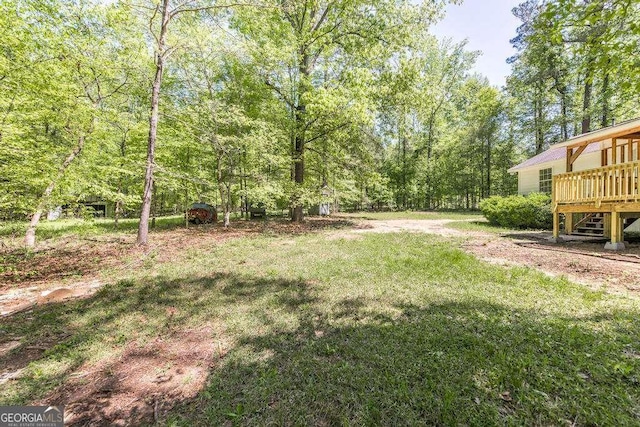 321 Riverbend Ct, Macon, GA 31211 - view of grassy yard with a deck and a view of trees