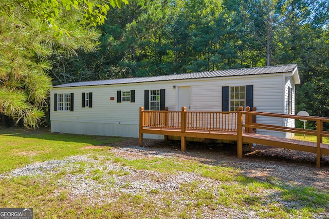 489 Berkeley Rd, Carlton, GA 30627 - manufactured / mobile home featuring a deck, a metal roof, and a front lawn