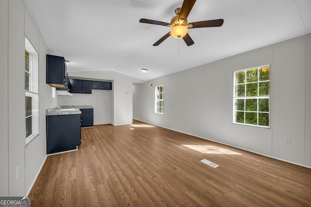 489 Berkeley Rd, Carlton, GA 30627 - unfurnished living room featuring wood finished floors, lofted ceiling, and ceiling fan