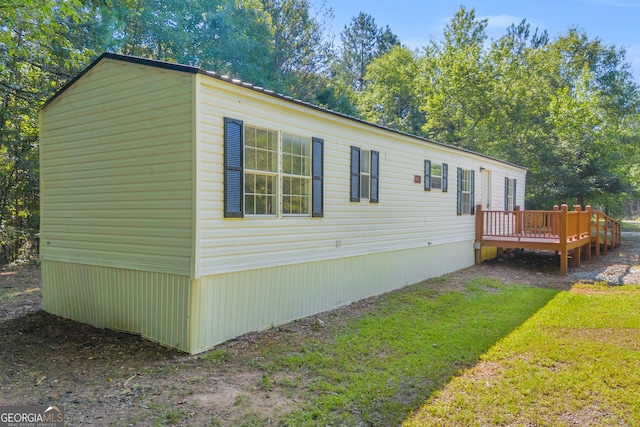 489 Berkeley Rd, Carlton, GA 30627 - view of property exterior featuring a deck and a lawn