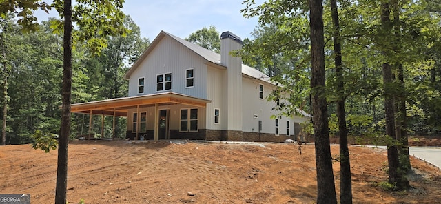 507 N Ridge Rd, Barnesville, GA 30204 - rear view of house featuring a chimney and stone siding