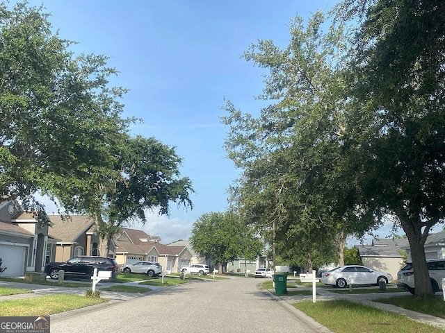 24910 Oakhaven Ct, Lutz, FL 33559 - view of asphalt road featuring a residential view, curbs, and sidewalks