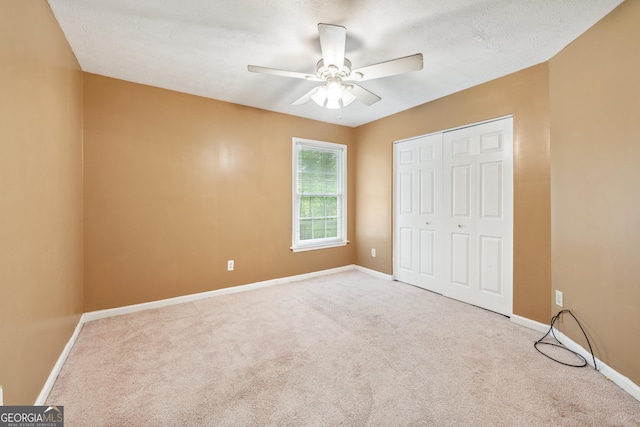 10044 Point View Dr, Jonesboro, GA 30238 - unfurnished bedroom with carpet, a closet, and a ceiling fan