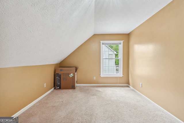 10044 Point View Dr, Jonesboro, GA 30238 - bonus room with lofted ceiling, a textured ceiling, and carpet flooring