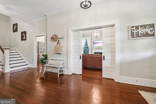 365 Seavy St, Senoia, GA 30276 - entryway with stairway, a chandelier, crown molding, and wood finished floors