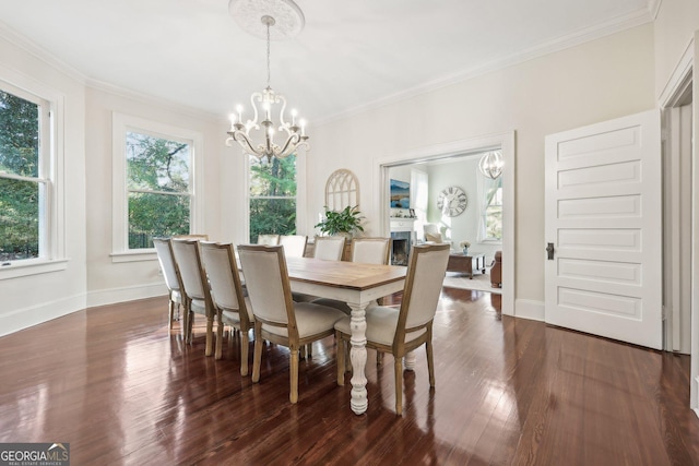 365 Seavy St, Senoia, GA 30276 - dining space with a chandelier, crown molding, and dark wood-style floors