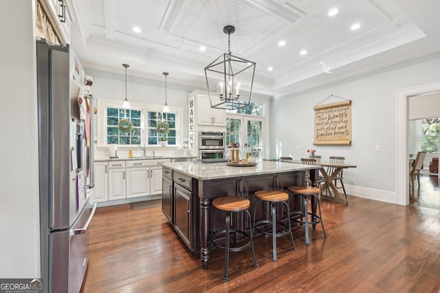 365 Seavy St, Senoia, GA 30276 - kitchen with crown molding, white cabinetry, a kitchen island, appliances with stainless steel finishes, and dark wood-type flooring