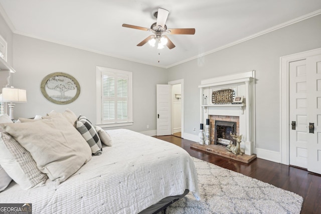 365 Seavy St, Senoia, GA 30276 - bedroom featuring wood finished floors, a stone fireplace, crown molding, and ceiling fan