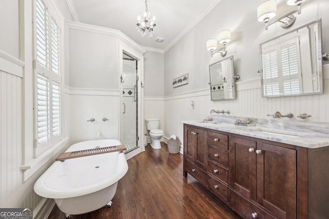 365 Seavy St, Senoia, GA 30276 - full bathroom with a chandelier, a stall shower, double vanity, a wainscoted wall, and wood finished floors