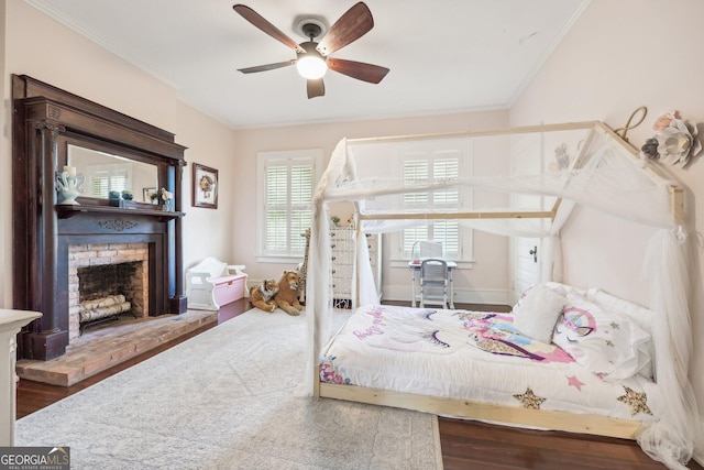 365 Seavy St, Senoia, GA 30276 - bedroom featuring ornamental molding, wood finished floors, a fireplace, and a ceiling fan