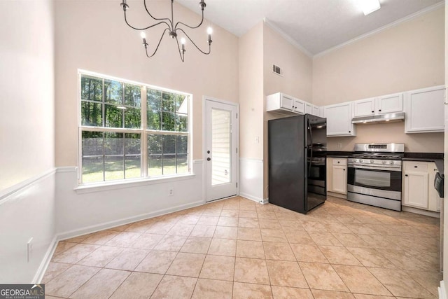 20 Four Oaks, Newnan, GA 30263 - kitchen featuring freestanding refrigerator, gas range, a high ceiling, crown molding, and dark countertops