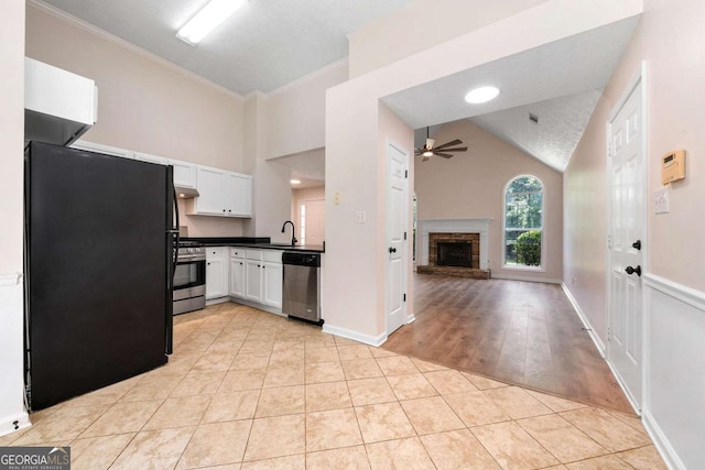 20 Four Oaks, Newnan, GA 30263 - kitchen with appliances with stainless steel finishes, ceiling fan, a fireplace, white cabinetry, and dark countertops