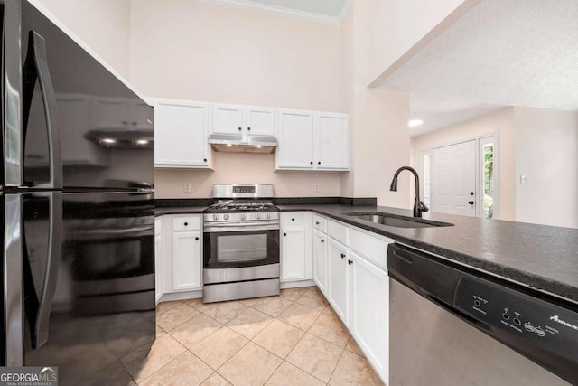 20 Four Oaks, Newnan, GA 30263 - kitchen featuring appliances with stainless steel finishes, dark countertops, white cabinets, crown molding, and light tile patterned floors
