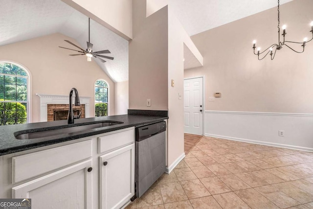20 Four Oaks, Newnan, GA 30263 - kitchen featuring dishwasher, vaulted ceiling, a chandelier, white cabinets, and a fireplace