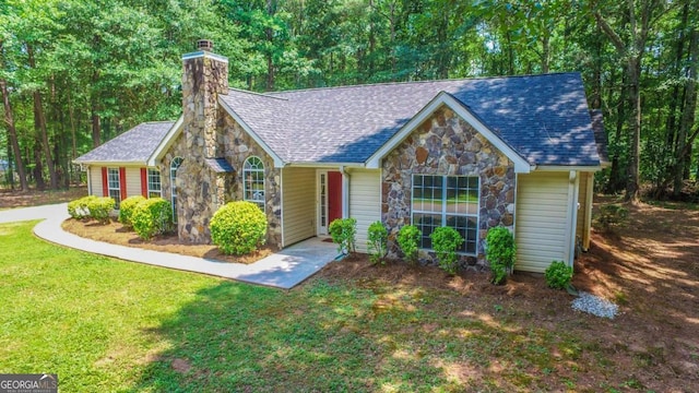 20 Four Oaks, Newnan, GA 30263 - view of front of home featuring stone siding, a chimney, a front lawn, and a shingled roof