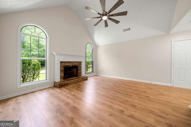 20 Four Oaks, Newnan, GA 30263 - unfurnished living room featuring a ceiling fan, light wood-style floors, high vaulted ceiling, and a fireplace