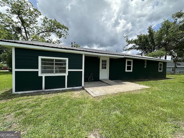 210 W Graham St, Mcrae-Helena, GA 31055 - rear view of house with a patio, a yard, and a metal roof
