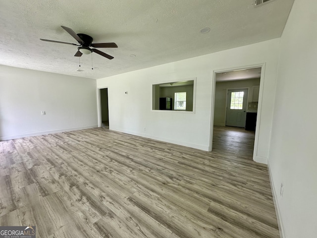 210 W Graham St, Mcrae-Helena, GA 31055 - unfurnished living room featuring a textured ceiling, wood finished floors, and ceiling fan