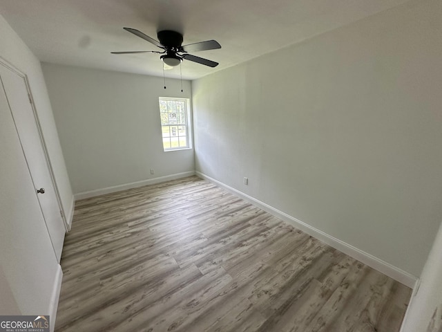 210 W Graham St, Mcrae-Helena, GA 31055 - unfurnished bedroom featuring light wood-style flooring and a ceiling fan